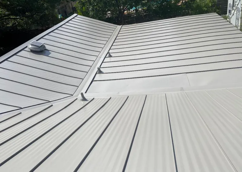Solar attic fan installed on a metal roof for Roof Ventilation in Moreau